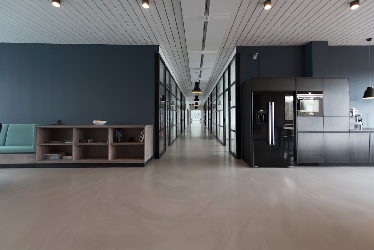 Team collaborating in a modern office with geometric ceiling lighting